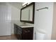 Bathroom with dark wood vanity, white countertop, and a large mirror at 7009 E Acoma Dr # 2013, Scottsdale, AZ 85254