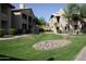 Beautifully maintained apartment building with lush green lawns and natural stone landscaping at 7009 E Acoma Dr # 2013, Scottsdale, AZ 85254
