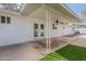 Covered back patio features a ceiling fan, white stucco walls, and beautiful outdoor space at 711 N 22Nd St, Mesa, AZ 85213