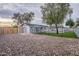 Large backyard with rock landscaping, privacy fence, grassy area, and swimming pool at 711 N 22Nd St, Mesa, AZ 85213