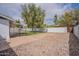 Fully fenced backyard with rock landscaping and view of the grassy area and pool at 711 N 22Nd St, Mesa, AZ 85213