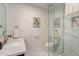 Well-lit bathroom features a marble tiled shower, glass door, and decorative elements at 711 N 22Nd St, Mesa, AZ 85213
