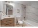 Bathroom vanity with white marble countertop, a mirror, a toilet, and a tub at 711 N 22Nd St, Mesa, AZ 85213