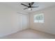 This bedroom has neutral carpet, a ceiling fan, and a window for natural light at 711 N 22Nd St, Mesa, AZ 85213