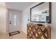 Entryway with a decorative white door, wood-look floors, and a mirrored accent table at 711 N 22Nd St, Mesa, AZ 85213