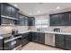 This modern kitchen is equipped with stainless steel appliances and attractive gray cabinetry at 711 N 22Nd St, Mesa, AZ 85213