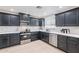 Stylish kitchen featuring dark cabinets, stainless steel appliances, and wood floors at 711 N 22Nd St, Mesa, AZ 85213