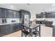 Modern kitchen boasts stainless steel appliances, gray cabinets and eat in kitchen dining table at 711 N 22Nd St, Mesa, AZ 85213