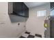 The laundry room has black and white tile floors and black overhead cabinets at 711 N 22Nd St, Mesa, AZ 85213