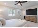 This main bedroom has neutral carpet, a ceiling fan, and an entertainment center at 711 N 22Nd St, Mesa, AZ 85213