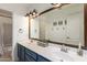 Bathroom with double sink vanity, large mirror, white walls, and shower-tub combination at 7170 W Crystal Rd, Glendale, AZ 85308