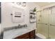 Bathroom with marble countertop vanity, decorative mirror, and glass shower at 7170 W Crystal Rd, Glendale, AZ 85308