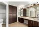Bathroom featuring double sinks, tiled floors and a separate toilet area at 7170 W Crystal Rd, Glendale, AZ 85308