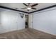 Bedroom with ceiling fan, closet, and view of bathroom and hallway at 7170 W Crystal Rd, Glendale, AZ 85308