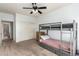 Bunk bed bedroom with ceiling fan, dresser, large window, and closet at 7170 W Crystal Rd, Glendale, AZ 85308
