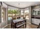 Dining area with backyard pool view featuring neutral walls, wood floors and natural light at 7170 W Crystal Rd, Glendale, AZ 85308