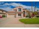 Charming two-story home featuring a well-manicured lawn, mature trees, and a tile roof at 7170 W Crystal Rd, Glendale, AZ 85308