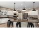 Spacious kitchen with granite counters, stainless steel appliances and modern pendant lighting at 7170 W Crystal Rd, Glendale, AZ 85308