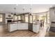 Open concept kitchen featuring an island with bar seating and a view of the dining and living areas at 7170 W Crystal Rd, Glendale, AZ 85308