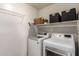 Well-organized laundry room featuring modern washer and dryer, shelving, and ample storage space at 7170 W Crystal Rd, Glendale, AZ 85308