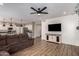 Open living room and kitchen space with wood floors, a ceiling fan, and comfortable brown seating at 7170 W Crystal Rd, Glendale, AZ 85308