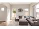 Bright living room with recessed lighting, wood floors, a large sectional sofa, and floating shelves at 7170 W Crystal Rd, Glendale, AZ 85308