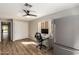 Office with hardwood floors, window, desk, chair, closet, and refrigerator at 7170 W Crystal Rd, Glendale, AZ 85308