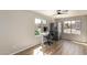 Office featuring a window, desk, chair, hardwood floors, and refrigerator at 7170 W Crystal Rd, Glendale, AZ 85308