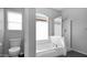 Bathroom featuring a shower over tub with a glass enclosure and a large window at 740 N Bradley Dr, Chandler, AZ 85226