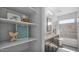 Bright bathroom featuring double vanity, shelving, and a tub shower combo at 740 N Bradley Dr, Chandler, AZ 85226