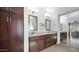Bathroom featuring double vanity with dark wood cabinetry, large mirrors, and a separate closet at 740 N Bradley Dr, Chandler, AZ 85226
