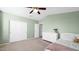 Bedroom featuring a ceiling fan, neutral carpet, and double door closet at 740 N Bradley Dr, Chandler, AZ 85226