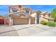 Inviting two-story home with a three-car garage, well-maintained lawn, and charming exterior details at 740 N Bradley Dr, Chandler, AZ 85226