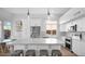 Modern kitchen boasting white cabinets, stainless steel appliances, and a large island with pendant lighting at 740 N Bradley Dr, Chandler, AZ 85226