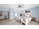 Serene main bedroom featuring soft blue walls, carpet flooring, a ceiling fan, and a king-size bed at 740 N Bradley Dr, Chandler, AZ 85226