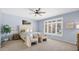 Calm main bedroom with soft blue walls, shutters, carpet, a ceiling fan, and a view to the backyard at 740 N Bradley Dr, Chandler, AZ 85226