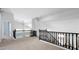 Upstairs landing featuring railing with black iron spindles and views of high ceilings at 740 N Bradley Dr, Chandler, AZ 85226