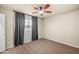 Carpeted bedroom features a ceiling fan and a window providing natural light at 7605 N 45Th Dr, Glendale, AZ 85301