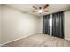 Bedroom with neutral walls, carpet, ceiling fan and stylish window coverings, a relaxing retreat at 7605 N 45Th Dr, Glendale, AZ 85301
