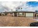 Charming single-story brick home featuring a two-car garage and palm trees in the front yard at 7605 N 45Th Dr, Glendale, AZ 85301