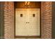 Double front doors with a charming light fixture and brick surround at 7605 N 45Th Dr, Glendale, AZ 85301