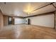 Spacious garage with storage cabinets, a refrigerator, and ample room for parking and projects at 7605 N 45Th Dr, Glendale, AZ 85301