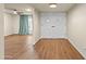 View of a bright hallway with wood-look flooring, double doors, and an open living area at 7605 N 45Th Dr, Glendale, AZ 85301
