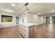 Kitchen island featuring modern light fixture, and hardwood floors at 7605 N 45Th Dr, Glendale, AZ 85301