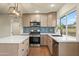 Modern kitchen featuring an island, stainless appliances, gas range, and stylish backsplash at 7605 N 45Th Dr, Glendale, AZ 85301