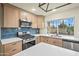 Stylish kitchen featuring stainless appliances, quartz countertops and blue tile backsplash at 7605 N 45Th Dr, Glendale, AZ 85301