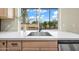 A well-lit stainless steel kitchen sink sits in front of a large window at 7605 N 45Th Dr, Glendale, AZ 85301