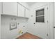 Spacious laundry room with white cabinets and utility sink at 7605 N 45Th Dr, Glendale, AZ 85301