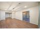 Bright living room with wood-look flooring, recessed lighting, and sliding glass door access at 7605 N 45Th Dr, Glendale, AZ 85301