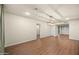 Spacious living room with wood-look flooring, recessed lighting, and neutral paint at 7605 N 45Th Dr, Glendale, AZ 85301